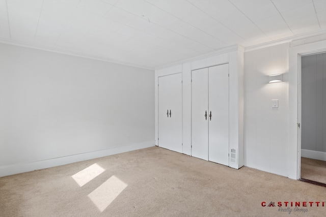 unfurnished bedroom with light colored carpet and ornamental molding