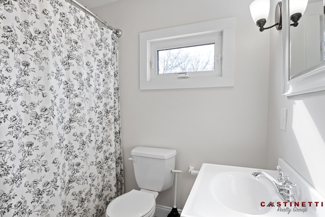 bathroom with walk in shower, vanity, and toilet