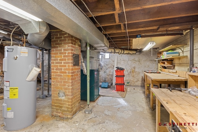 basement with heating unit, a workshop area, and electric water heater