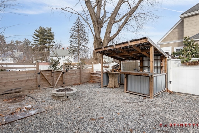 view of yard featuring an outdoor fire pit and an outdoor structure