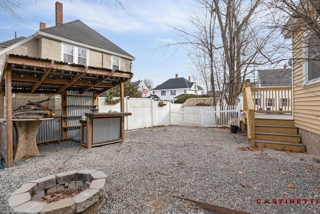 view of yard featuring a wooden deck and an outdoor fire pit