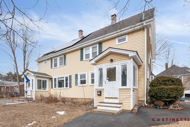 colonial inspired home with solar panels