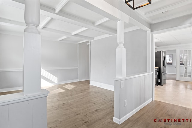 unfurnished living room with decorative columns, coffered ceiling, beamed ceiling, and light hardwood / wood-style flooring