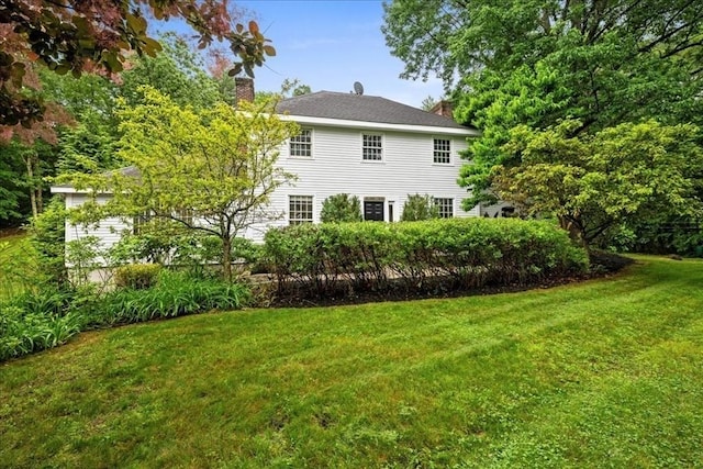 188 N Main St, Uxbridge, MA 01569 - rear view of house featuring a chimney and a yard