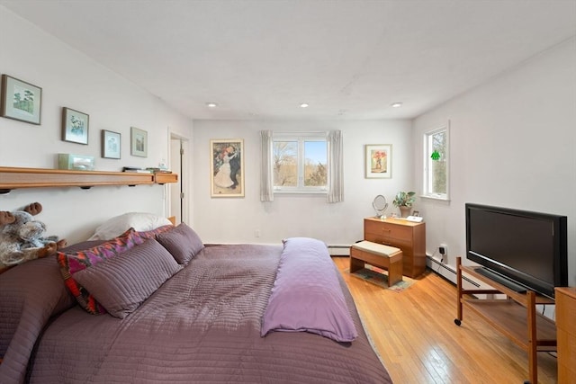 bedroom featuring multiple windows, light wood-style floors, recessed lighting, and a baseboard radiator