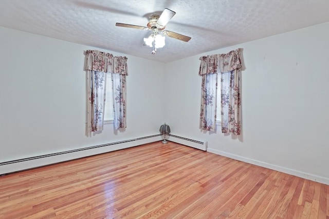 20 Amherst St, Grafton, MA 01536 - spare room featuring wood finished floors, a textured ceiling, a ceiling fan, baseboards, and a baseboard heating unit