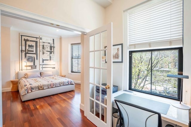 bedroom with wood-type flooring and ornamental molding