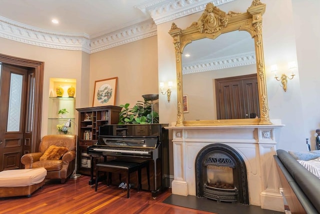 living area with dark hardwood / wood-style flooring and ornamental molding