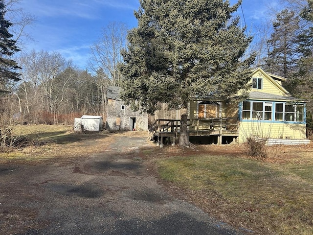 view of yard featuring a wooden deck and a sunroom