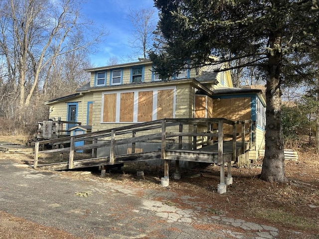 back of property with a wooden deck