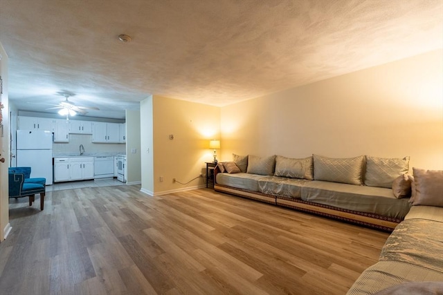 420 Great Rd Unit B9, Acton, MA 01720 - living area with wood finished floors, baseboards, and ceiling fan
