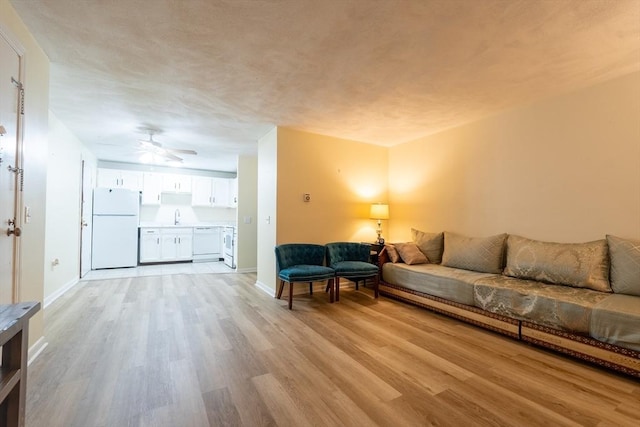 420 Great Rd Unit B9, Acton, MA 01720 - living room with light wood-type flooring, baseboards, and a ceiling fan
