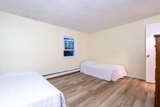 420 Great Rd Unit B9, Acton, MA 01720 - bedroom featuring baseboard heating, wood finished floors, and baseboards