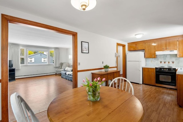 dining area with a baseboard radiator and wood finished floors