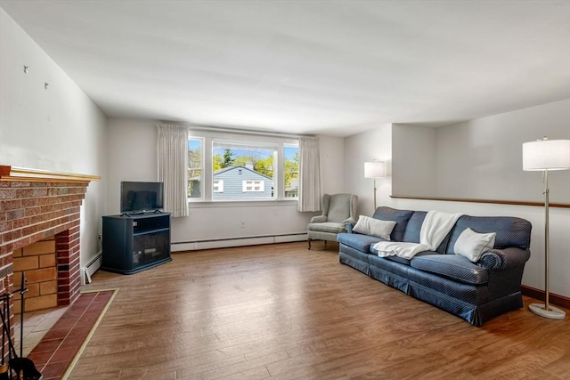 living room with a fireplace, wood finished floors, and a baseboard radiator
