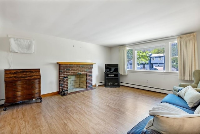 living room with a baseboard radiator, a baseboard heating unit, wood finished floors, and a brick fireplace