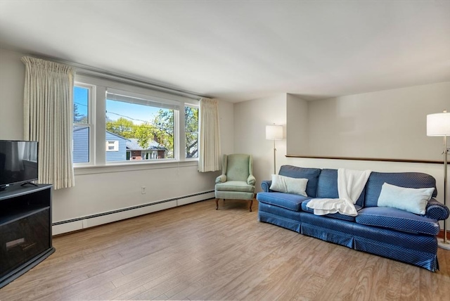 living room with a baseboard radiator and wood finished floors