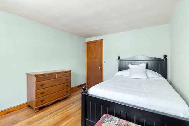 bedroom with baseboards and light wood-style floors