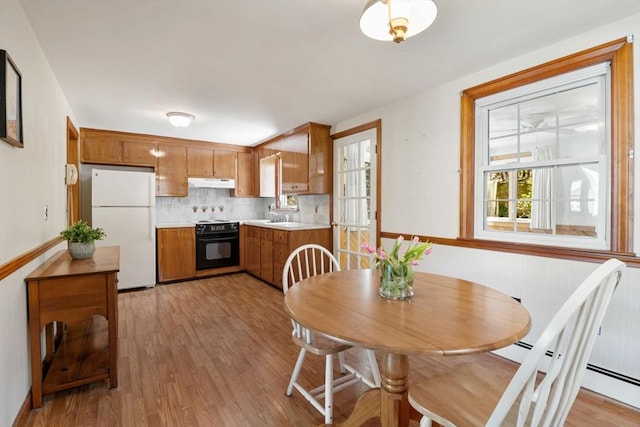 dining area featuring light wood-style flooring