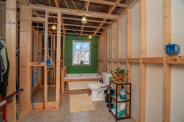 bathroom featuring a bath and toilet