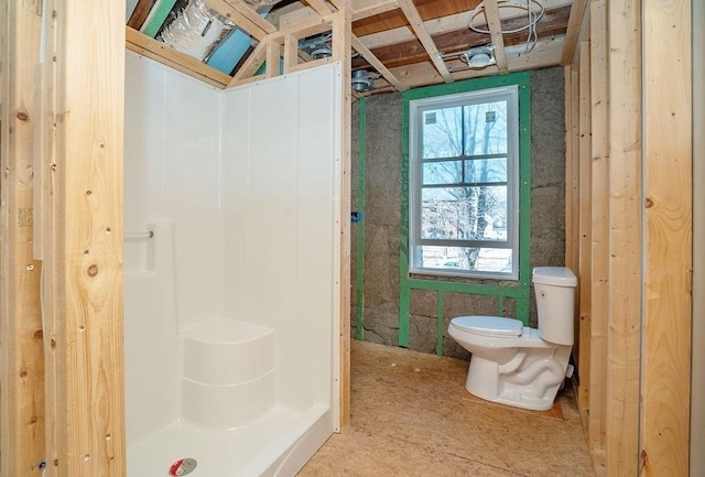 full bath featuring toilet and a stall shower