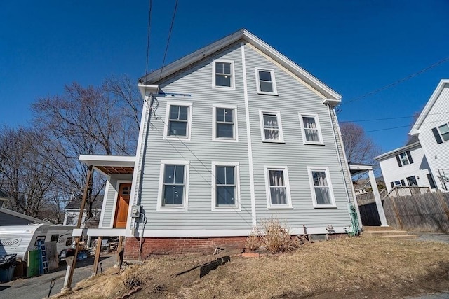 rear view of property with fence