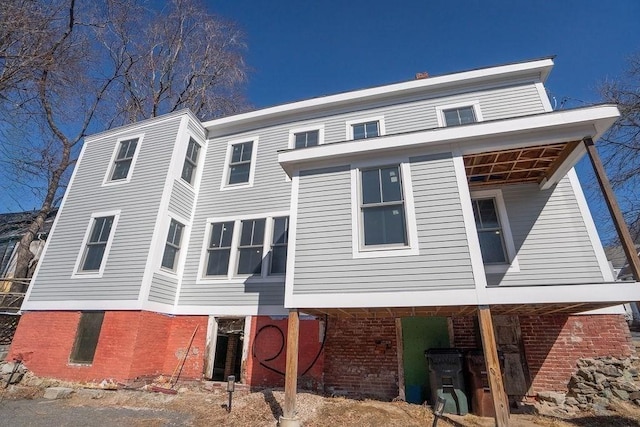 rear view of property with brick siding