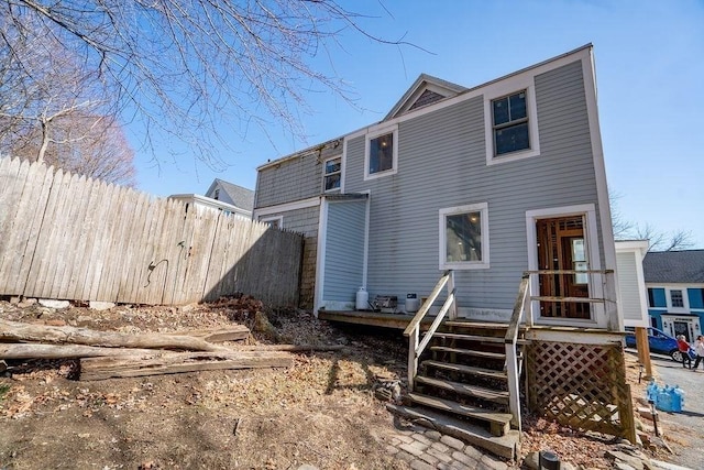 back of house featuring fence