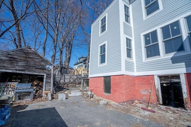 view of side of home featuring brick siding