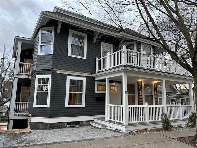 view of front of home with a balcony and covered porch