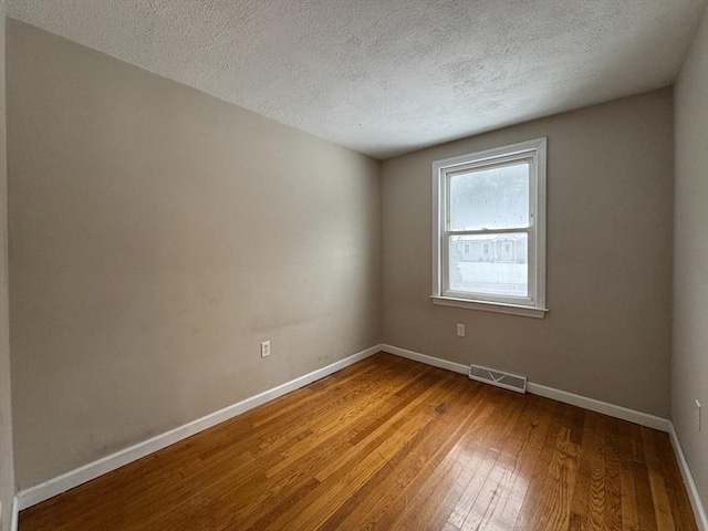 2248 Washington St, East Bridgewater, MA 02333 - unfurnished room featuring wood-type flooring, visible vents, a textured ceiling, and baseboards