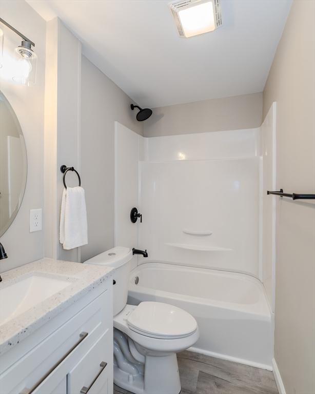 bathroom with shower / bath combination, visible vents, toilet, wood finished floors, and vanity