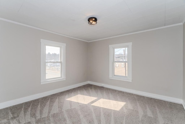 carpeted spare room featuring baseboards and ornamental molding