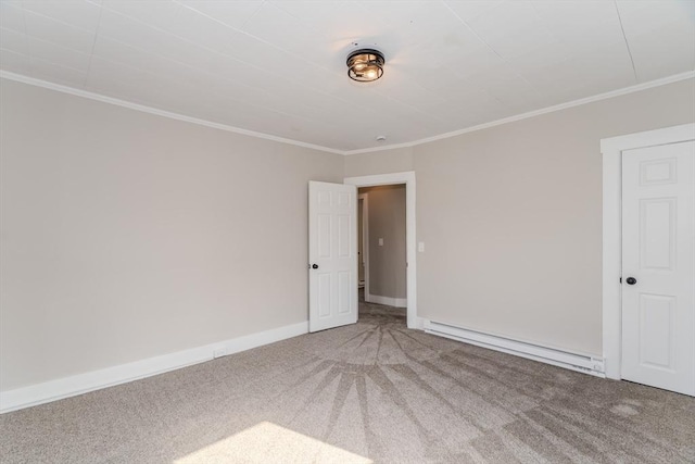 carpeted empty room featuring a baseboard radiator, baseboards, and crown molding