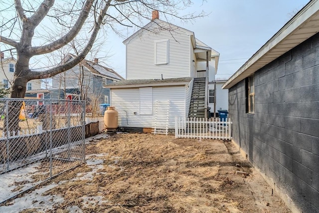 back of property with stairs and fence