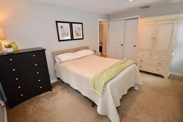 bedroom featuring visible vents, baseboards, a closet, and light colored carpet