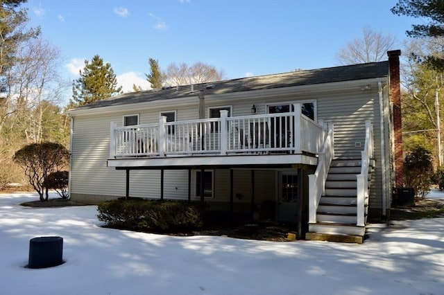 back of house with a deck, a chimney, and stairway