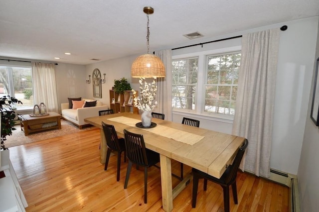 dining room with light wood-type flooring, visible vents, and recessed lighting