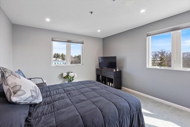 carpeted bedroom featuring recessed lighting and baseboards