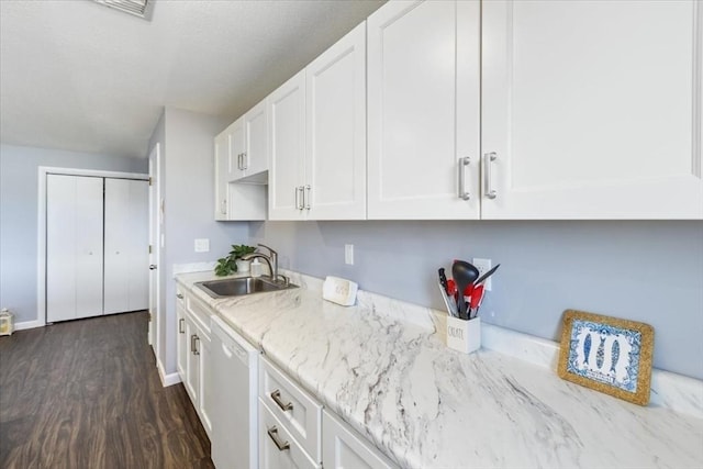 kitchen featuring a sink, dark wood-style floors, white cabinets, light stone countertops, and dishwasher