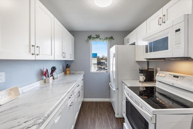 kitchen with white appliances, a textured ceiling, white cabinets, and dark wood-style flooring