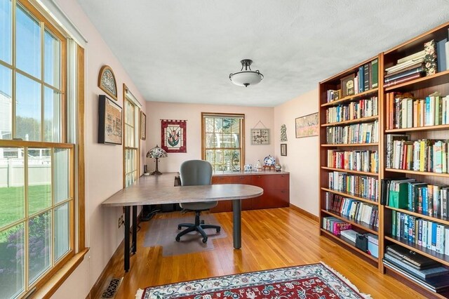 office space with wood finished floors and baseboards