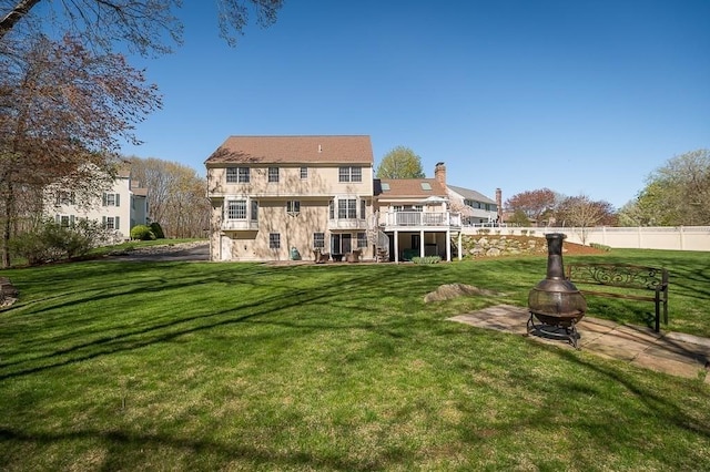 back of house featuring an outdoor fire pit, a chimney, stairs, a wooden deck, and a patio area