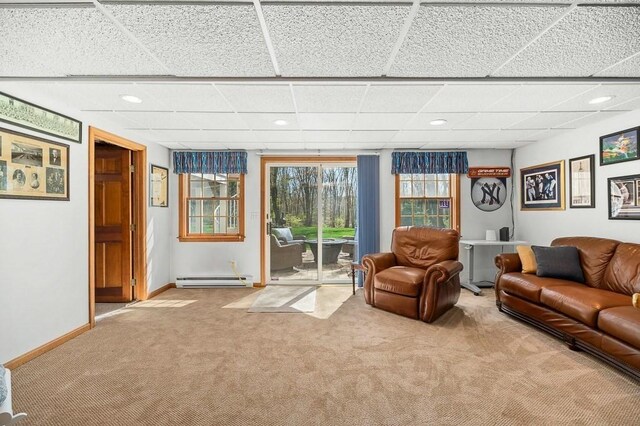 carpeted living area featuring baseboard heating, a paneled ceiling, baseboards, and recessed lighting