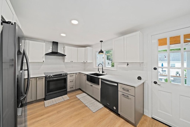 359 Corey St, Boston, MA 02132 - kitchen featuring wall chimney range hood, appliances with stainless steel finishes, a sink, decorative backsplash, and recessed lighting
