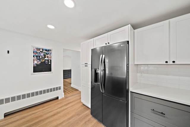359 Corey St, Boston, MA 02132 - kitchen with fridge with ice dispenser, radiator heating unit, gray cabinetry, light wood-type flooring, and light countertops