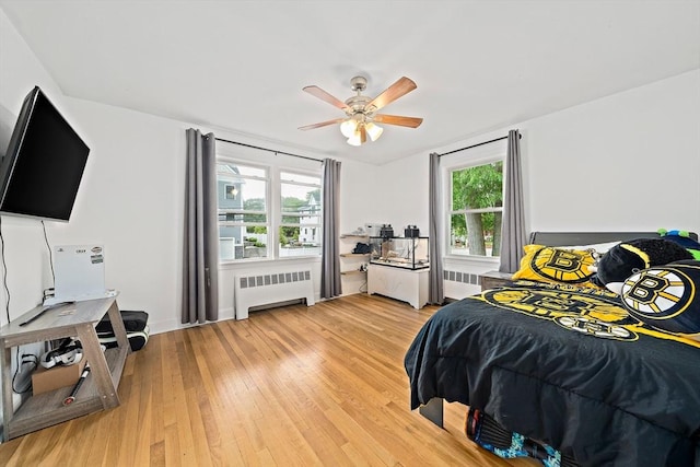 359 Corey St, Boston, MA 02132 - bedroom featuring radiator, light wood-style flooring, and ceiling fan