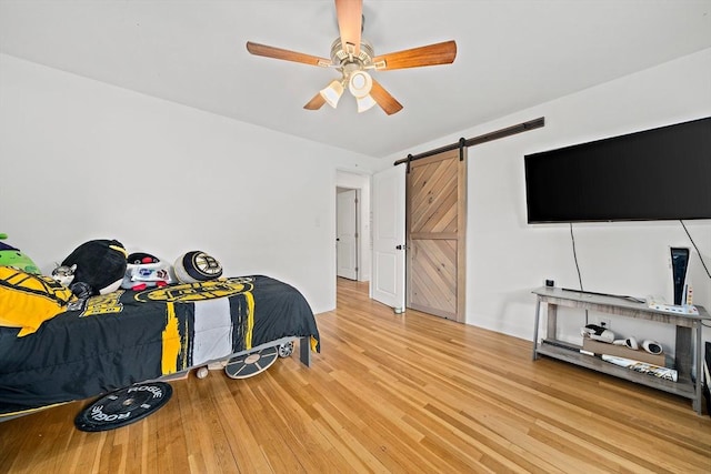 359 Corey St, Boston, MA 02132 - bedroom with a barn door, light wood finished floors, and ceiling fan