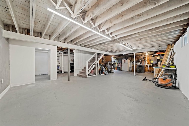 359 Corey St, Boston, MA 02132 - below grade area featuring stairway and freestanding refrigerator
