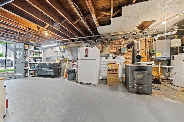 359 Corey St, Boston, MA 02132 - basement featuring freestanding refrigerator, gas water heater, and tankless water heater